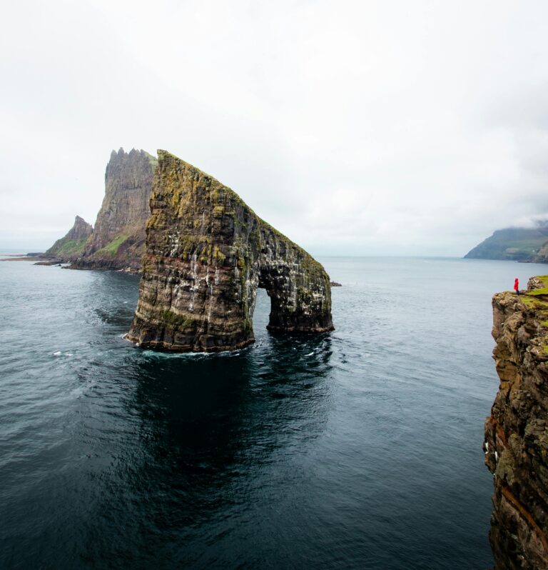 Breathtaking view of Drangarnir sea stacks in the Faroe Islands, showcasing natural beauty and rugged landscapes.